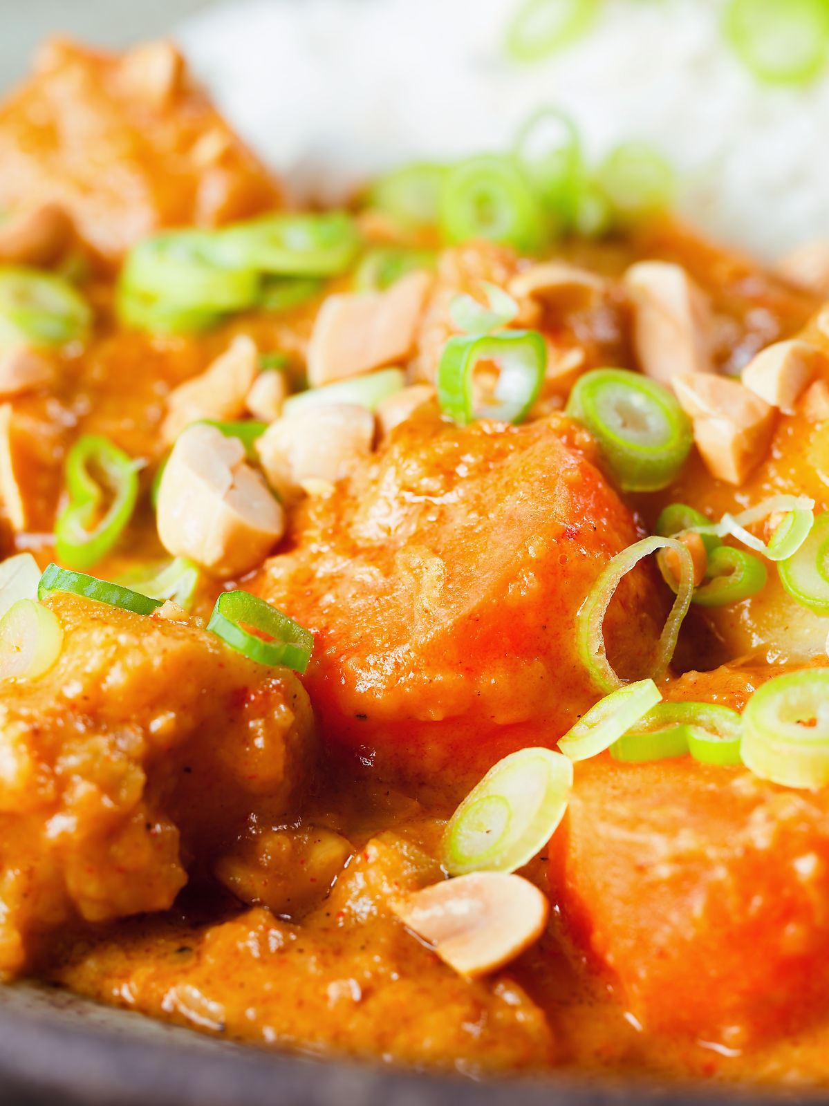 Close-up domoda a West African stew, vegan version with sweet potato and carrot, served with rice.