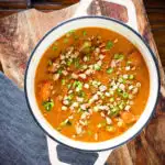 Overhead domoda a West African stew, vegan version with sweet potato and carrot in a pan.