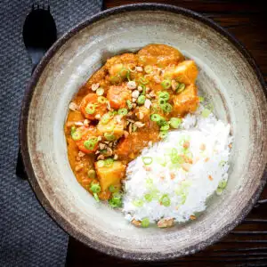 Domoda a West African (Gambian) stew, vegan version with sweet potato and carrot, served with rice.