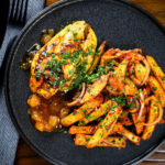 Overhead mango chutney chicken breast served with masala chips.