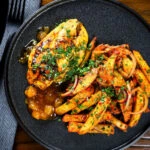 Overhead mango chutney chicken breast served with masala chips.