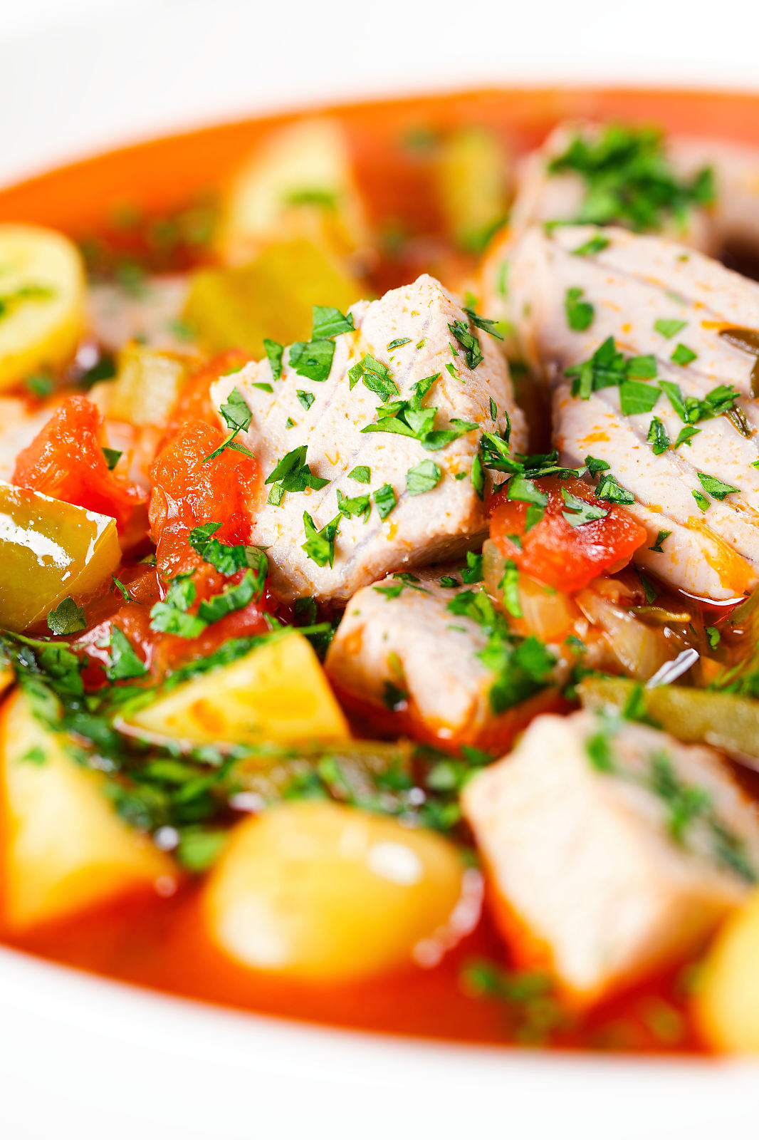 Close-up Marmitako, Basque tuna stew with potatoes, peppers and smoked paprika.