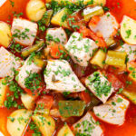 Close-up overhead Marmitako, Basque tuna stew with potatoes, peppers and smoked paprika.