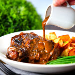 "Gravy" poured over Spanish-influenced braised oxtail (rabo de toro) served with green beans and potatoes.