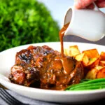 "Gravy" poured over Spanish-influenced braised oxtail (rabo de toro) served with green beans and potatoes.