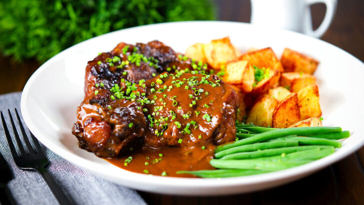 Spanish-influenced braised oxtail (rabo de toro) with roast potatoes and green beans.