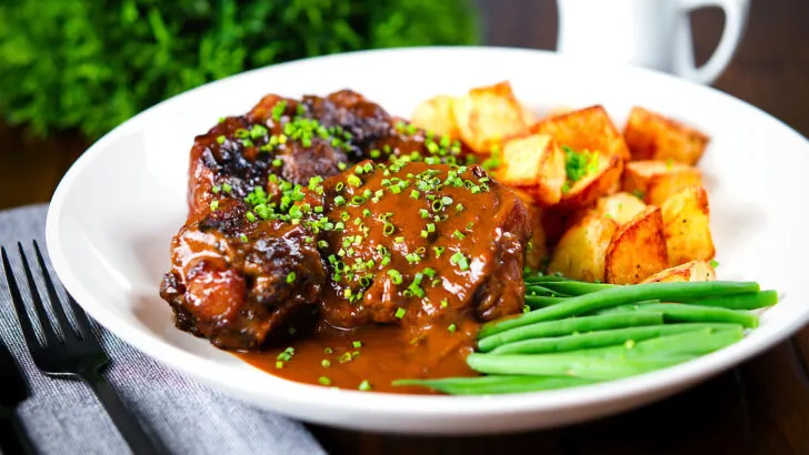 Spanish-influenced braised oxtail (rabo de toro) with roast potatoes and green beans.