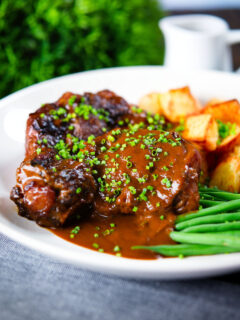 Spanish-influenced braised oxtail (rabo de toro) with mini roast potatoes and green beans.
