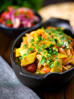 Taze fasulye (Turkish green bean stew) served with a side salad and flatbread.