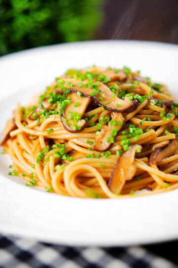 Vegetarian miso mushroom pasta (spaghetti) with snipped chives.