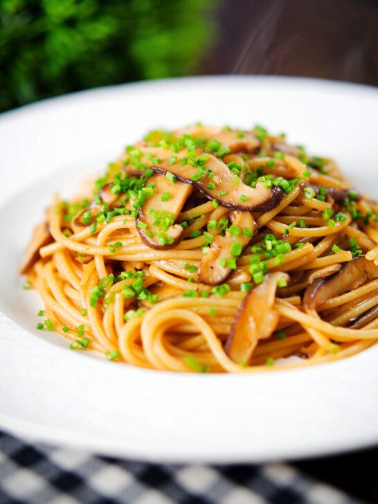 Vegetarian miso mushroom pasta (spaghetti) with snipped chives.