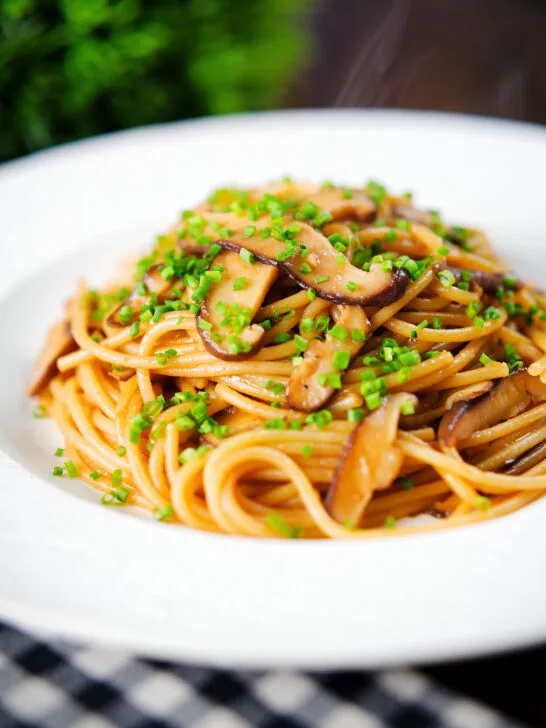 Vegetarian miso mushroom pasta (spaghetti) with snipped chives.