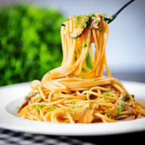 Vegetarian miso and shiitake mushroom pasta (spaghetti) with snipped chives.