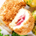 Overhead close-up air fryer chicken cordon bleu with buttered potatoes and broccoli.