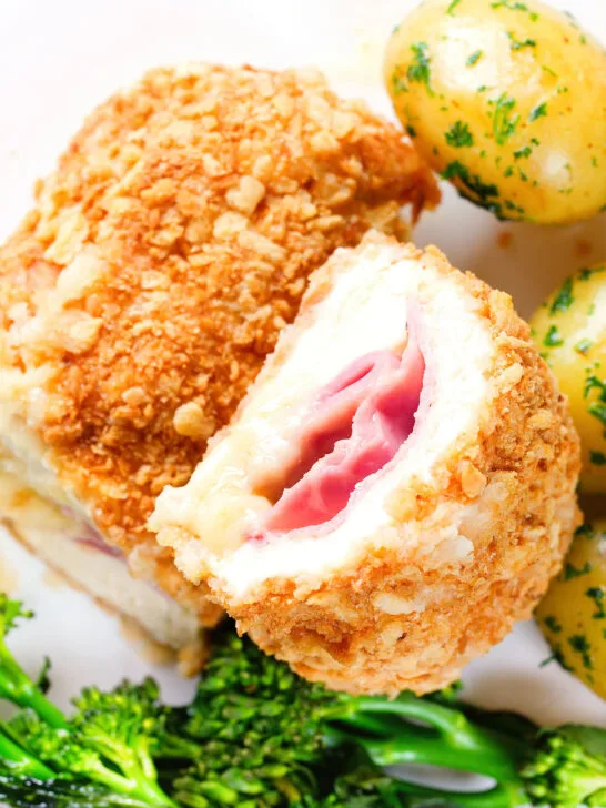 Overhead close-up air fryer chicken cordon bleu with buttered potatoes and broccoli.