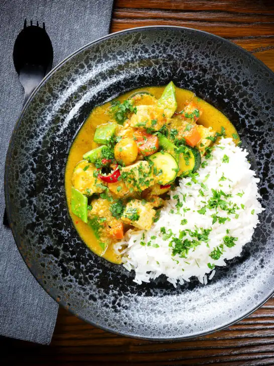 Overhead sayur kare, a Balinese vegetable and tofu curry served with Jasmine rice and fresh coriander.