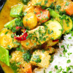 Close-up overhead sayur kare, a Balinese vegetable and tofu curry served with Jasmine rice and fresh coriander.