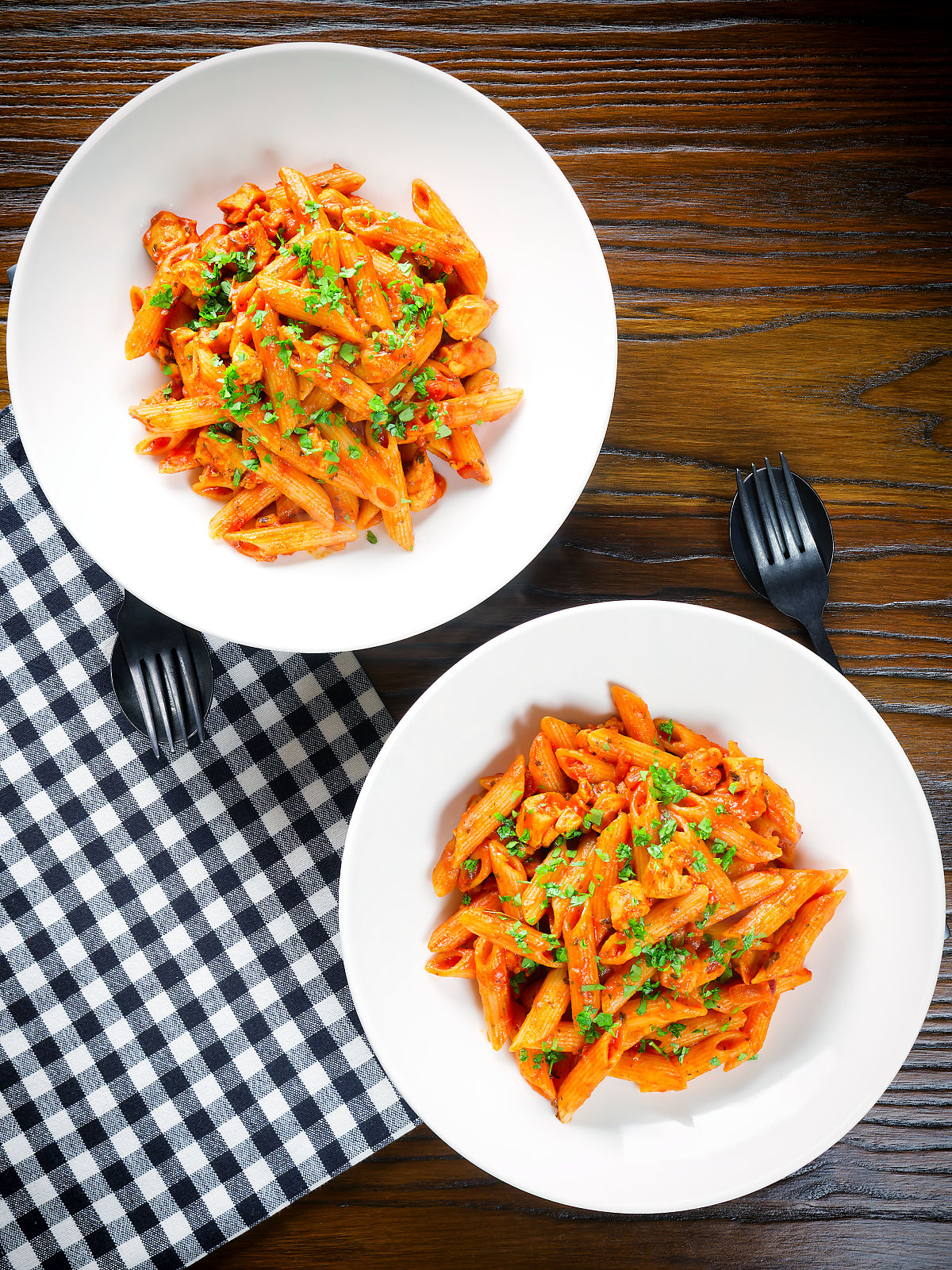 Overhead curry chicken pasta with Indian influences garnished with coriander.
