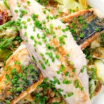 Close-up overhead mackerel fillets with horseradish, leek, potato and samphire hash.