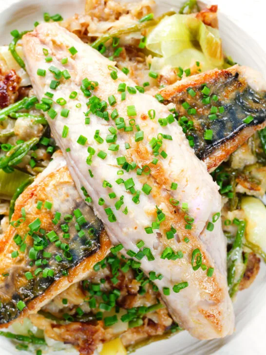 Close-up overhead mackerel fillets with horseradish, leek, potato and samphire hash.