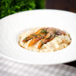 Pear, walnut and Gorgonzola cheese risotto with fried pear slices and fresh sage.