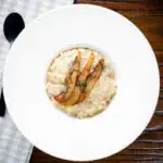 Overhead pear, walnut and Gorgonzola risotto with fried pear slices.