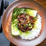 Overhead crispy Chinese salt and pepper pork belly bites with pak choi and Jasmine rice.