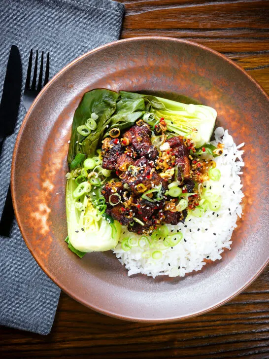 Overhead crispy Chinese salt and pepper pork belly bites with pak choi and Jasmine rice.