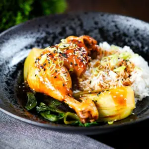 Chinese soy sauce braised chicken leg served with pak choi and white rice.
