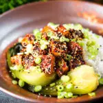 Spicy sticky sesame tofu served with pak choi and jasmine rice.