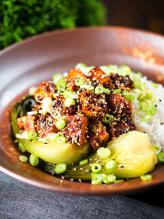 Spicy sticky sesame tofu served with pak choi and jasmine rice.