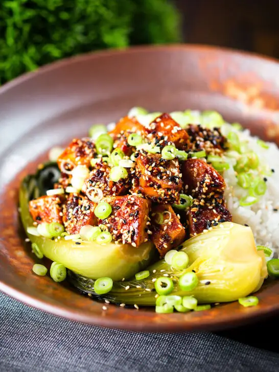 Spicy sticky sesame tofu served with pak choi and jasmine rice.