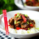 Spicy Thai basil and beef stir fry served with jasmine rice and spring onions.