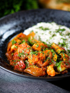 Vegan vegetable rogan josh curry with rice, naan and fresh coriander.