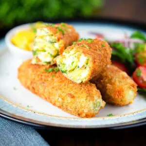 Crispy vegetarian Glamorgan sausages served with piccalilli and a side salad.