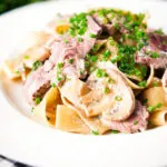 Creamy steak and mushroom pasta (pappardelle) with a "Diane" sauce and snipped chives.