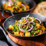 Minced beef, potato and pea curry (aloo keema matar) served with naan bread.