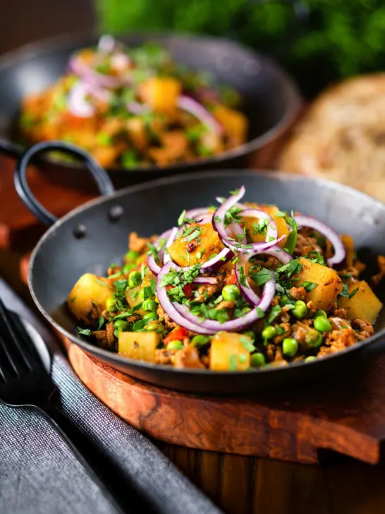 Minced beef, potato and pea curry (aloo keema matar) served with naan bread.