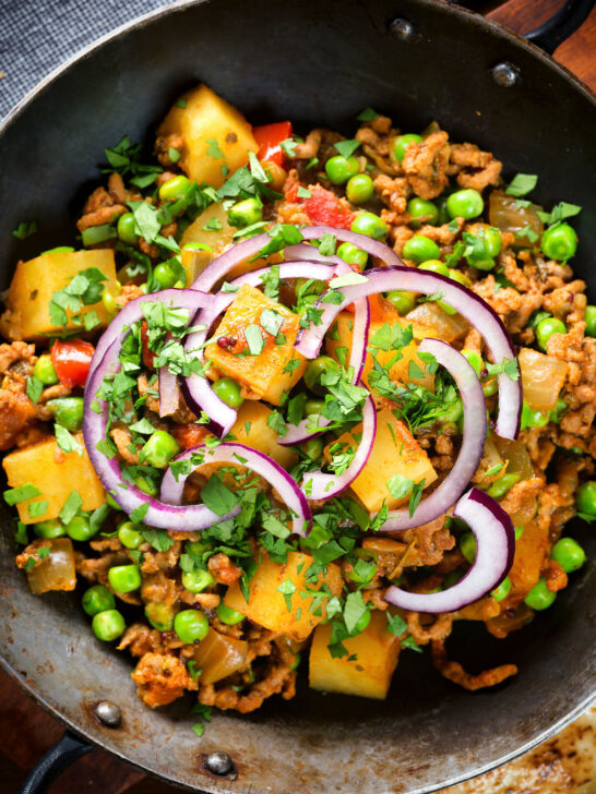 Overhead close-up minced beef, potato and pea curry (aloo keema matar).