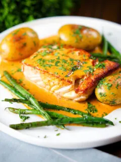 Pan fried halibut with Thai yellow curry sauce, potatoes, green beans and coriander.