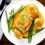 Overhead fried halibut with Thai yellow curry sauce, potatoes, green beans and coriander.