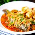 Bourdeto, whole sea bass stew in a paprika broth with crispy potatoes.