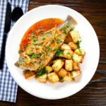 Sea bass bourdeto stew from Corfu with crispy roasted potatoes.