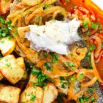 Overhead bourdeto, sea bass stew showing texture of cooked fish.