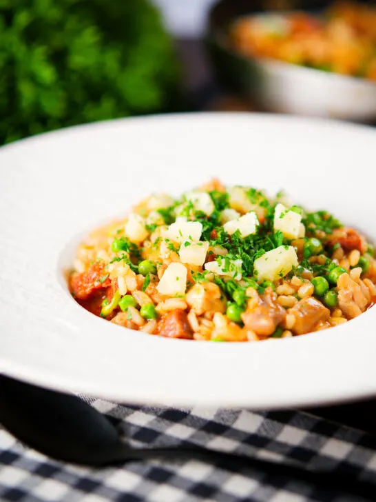 Chicken and chorizo risotto with peas, Manchego cheese and fresh parsley.