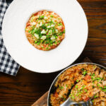 Overhead chicken and chorizo risotto with peas, Manchego cheese and fresh parsley.