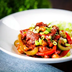 Indo-Chinese spicy dragon chicken served with white rice and spring onions