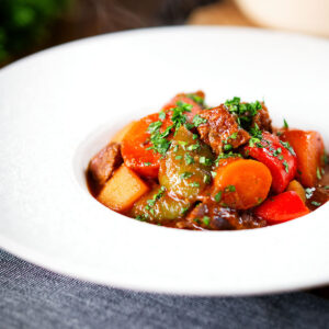 Filipino beef kaldereta (caldereta) stew with potatoes, carrots and peppers.