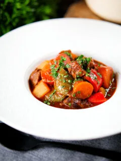 Filipino beef kaldereta (caldereta) stew garnished with coriander.