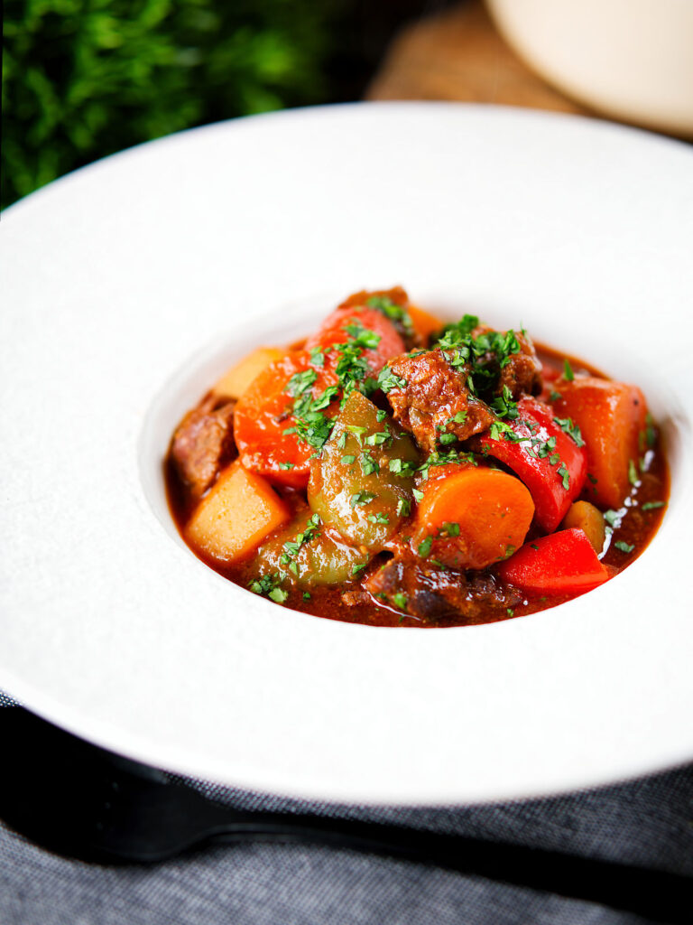 Filipino beef kaldereta (caldereta) stew garnished with coriander.
